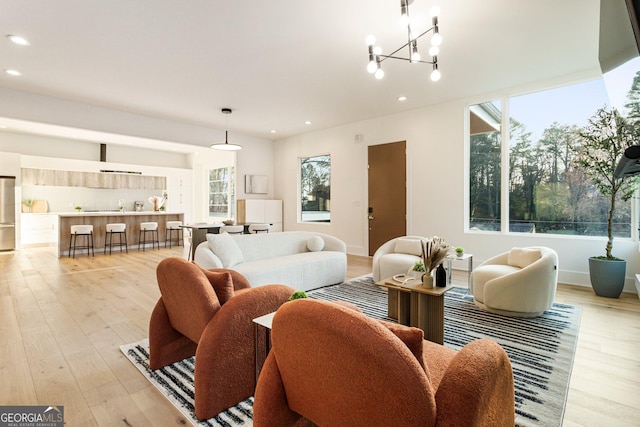1045 Shepherds Ln NE, Atlanta, GA 30324 - living area with healthy amount of natural light, recessed lighting, light wood finished floors, and a chandelier