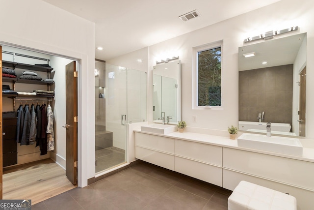 1045 Shepherds Ln NE, Atlanta, GA 30324 - bathroom with a shower stall, double vanity, a walk in closet, and tile patterned floors
