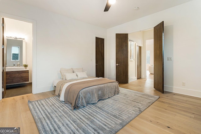 1045 Shepherds Ln NE, Atlanta, GA 30324 - bedroom with light wood-type flooring, ensuite bath, and ceiling fan