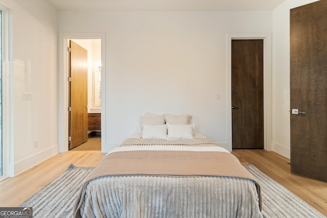1045 Shepherds Ln NE, Atlanta, GA 30324 - bedroom featuring light wood-style flooring and baseboards