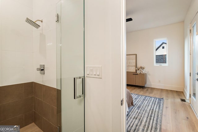 1045 Shepherds Ln NE, Atlanta, GA 30324 - bathroom with a stall shower, wood finished floors, and radiator heating unit