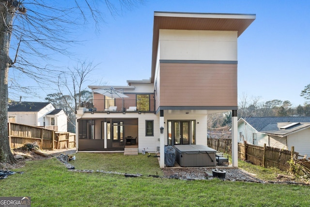 1045 Shepherds Ln NE, Atlanta, GA 30324 - back of property featuring a hot tub, a balcony, a fenced backyard, and a sunroom