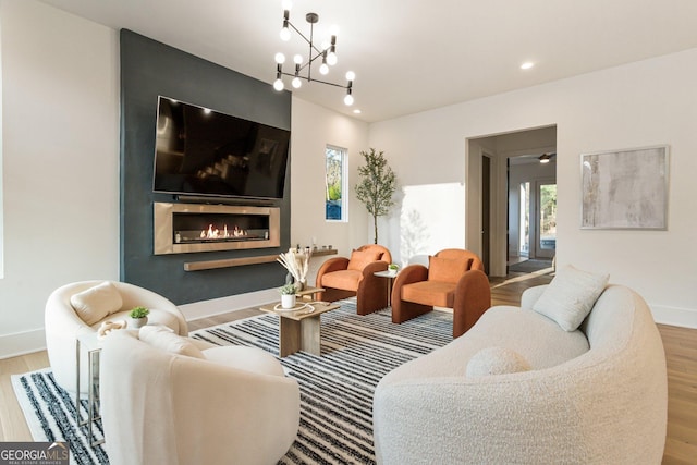 1045 Shepherds Ln NE, Atlanta, GA 30324 - living room featuring wood finished floors, a glass covered fireplace, a chandelier, and recessed lighting