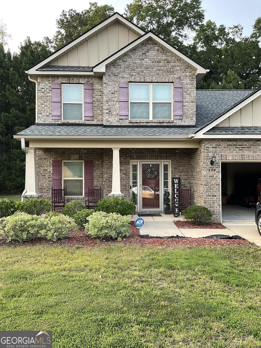 874 Crescent Ln Unit 52, Griffin, GA 30224 - craftsman house featuring roof with shingles, a front lawn, brick siding, and a porch
