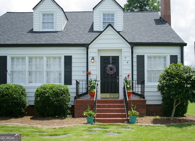 74 Hollis Hts, Newnan, GA 30263 - cape cod-style house with a shingled roof, a chimney, and a front yard