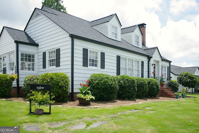 74 Hollis Hts, Newnan, GA 30263 - view of home's exterior with a lawn, a chimney, and a shingled roof