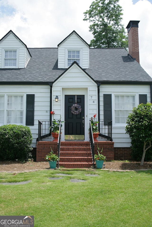 74 Hollis Hts, Newnan, GA 30263 - view of front of property featuring a front yard, a shingled roof, and a chimney