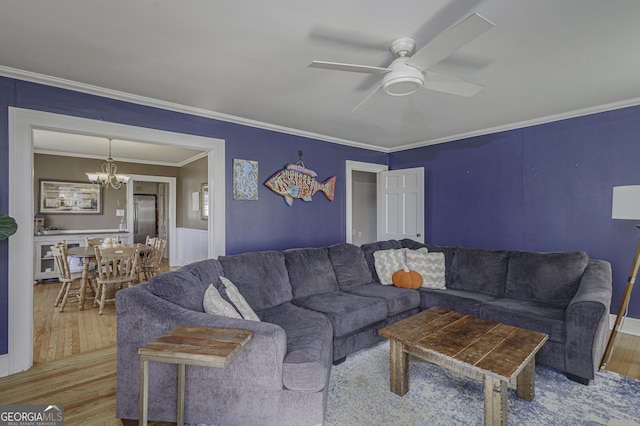 74 Hollis Hts, Newnan, GA 30263 - living area featuring wood finished floors, ceiling fan, a chandelier, crown molding, and wainscoting