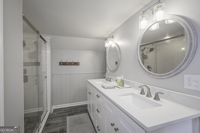 74 Hollis Hts, Newnan, GA 30263 - bathroom featuring double vanity, a shower stall, and wainscoting