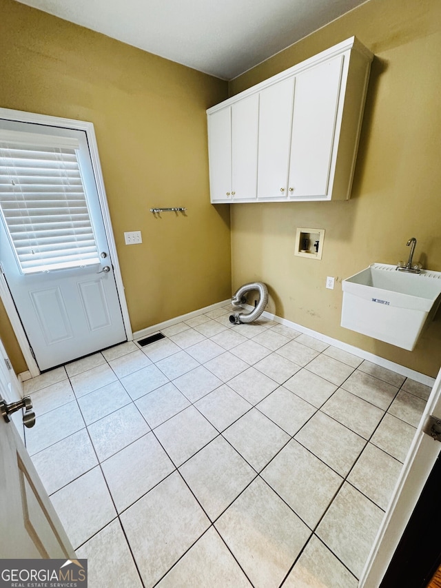 2640 Preston Ridge Ln, Dacula, GA 30019 - washroom with washer hookup, light tile patterned flooring, and cabinet space