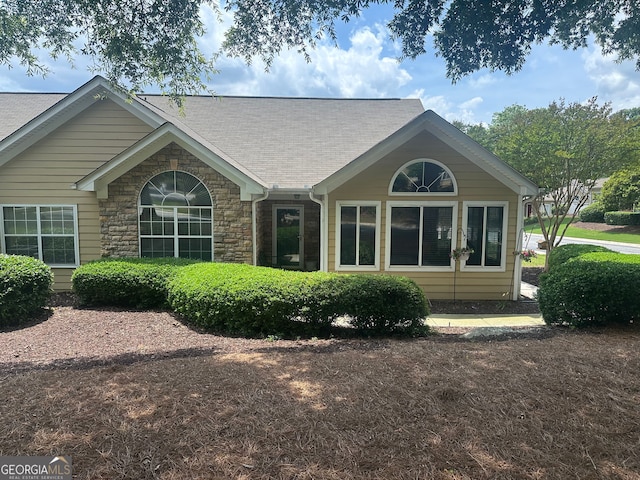 2191 SW Rockbridge Rd Unit 2603, Stone Mountain, GA 30087 - rear view of house featuring stone siding and a shingled roof