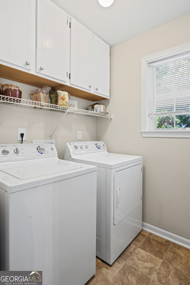 45 Paces Landing Dr, Newnan, GA 30263 - laundry room featuring cabinet space, washer and clothes dryer, baseboards, and a textured ceiling