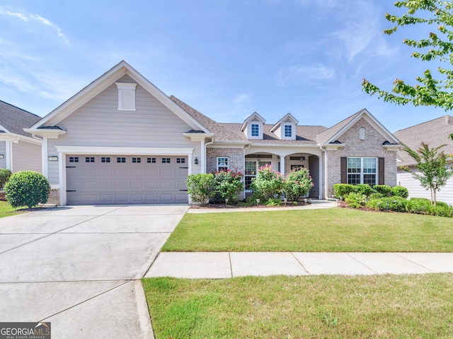 302 Burberry Ct, Griffin, GA 30223 - view of front facade featuring brick siding, a garage, driveway, and a front yard