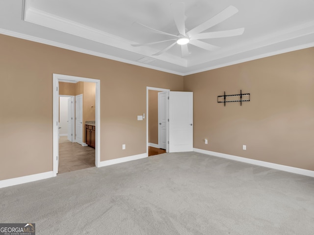 302 Burberry Ct, Griffin, GA 30223 - unfurnished bedroom with ornamental molding, a raised ceiling, light carpet, baseboards, and ensuite bath