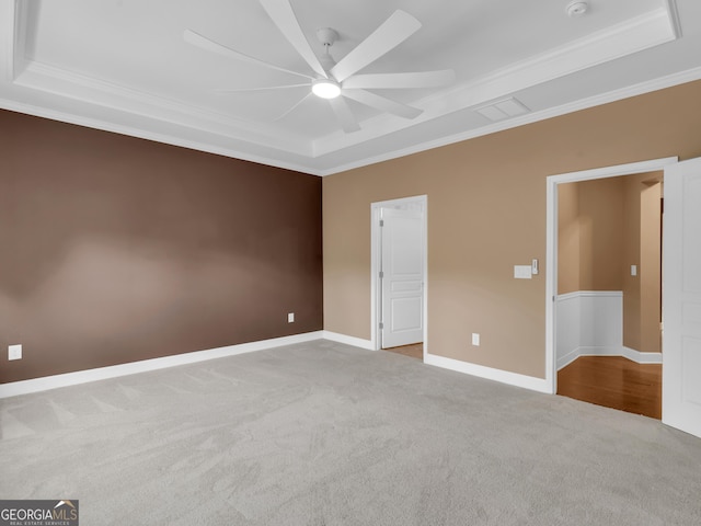 302 Burberry Ct, Griffin, GA 30223 - unfurnished bedroom featuring a tray ceiling, carpet floors, ornamental molding, baseboards, and a ceiling fan