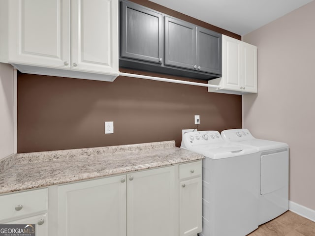 302 Burberry Ct, Griffin, GA 30223 - washroom featuring cabinet space, washing machine and clothes dryer, baseboards, and light tile patterned flooring