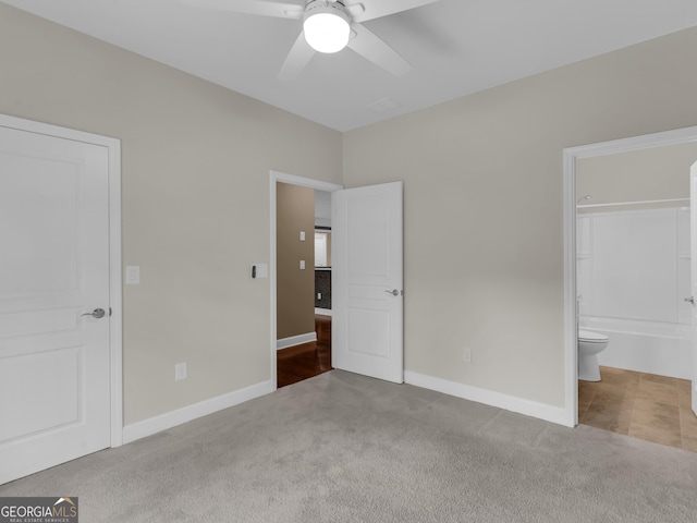 302 Burberry Ct, Griffin, GA 30223 - unfurnished bedroom with carpet flooring, baseboards, connected bathroom, and a ceiling fan