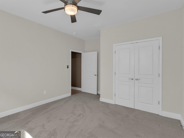302 Burberry Ct, Griffin, GA 30223 - unfurnished bedroom with carpet, a closet, baseboards, and a ceiling fan