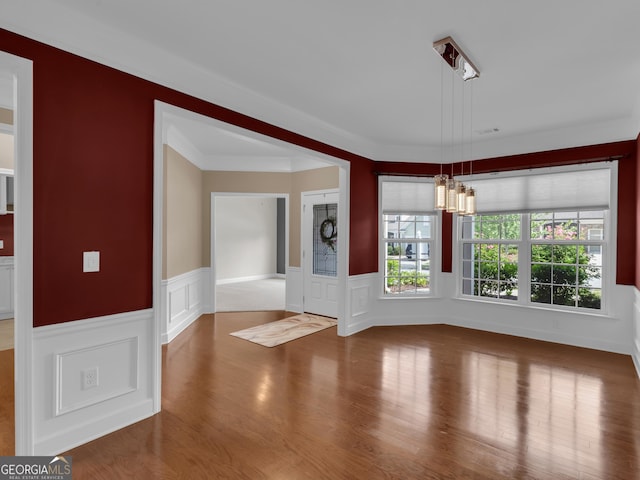 302 Burberry Ct, Griffin, GA 30223 - entrance foyer featuring a chandelier, wood finished floors, wainscoting, a decorative wall, and crown molding