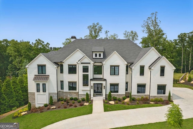 245 Traditions Dr, Alpharetta, GA 30004 - view of front facade featuring stone siding, a chimney, a front yard, and a standing seam roof