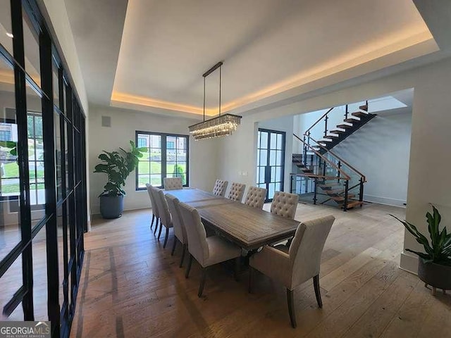 245 Traditions Dr, Alpharetta, GA 30004 - dining space with a tray ceiling, stairs, hardwood / wood-style flooring, and a chandelier