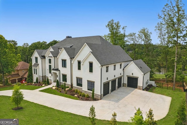 245 Traditions Dr, Alpharetta, GA 30004 - modern farmhouse style home with stone siding, concrete driveway, a front lawn, and roof with shingles