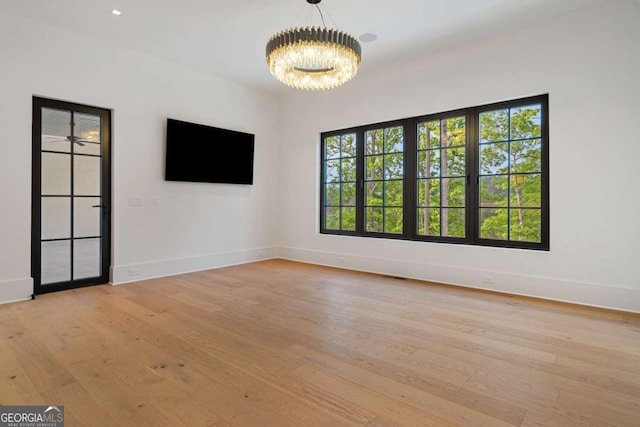 245 Traditions Dr, Alpharetta, GA 30004 - empty room featuring a chandelier and light wood-type flooring