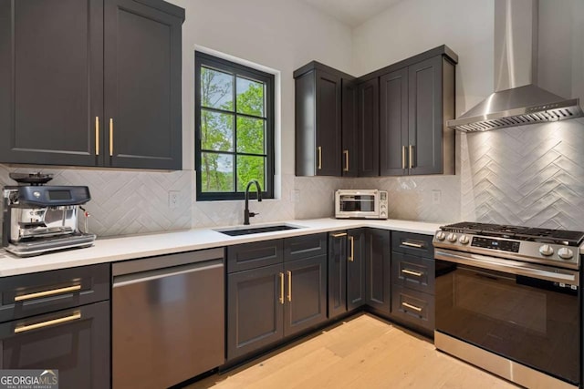 245 Traditions Dr, Alpharetta, GA 30004 - kitchen featuring stainless steel appliances, wall chimney exhaust hood, light wood finished floors, and light countertops