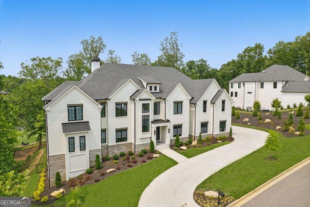 245 Traditions Dr, Alpharetta, GA 30004 - view of front of home featuring stone siding, a standing seam roof, a front lawn, and a chimney