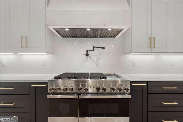 245 Traditions Dr, Alpharetta, GA 30004 - kitchen with range with two ovens, custom range hood, white cabinetry, and decorative backsplash