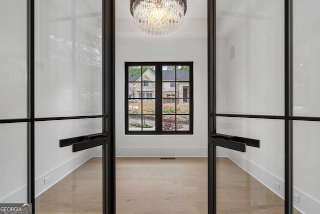 245 Traditions Dr, Alpharetta, GA 30004 - interior space with a chandelier and wood finished floors