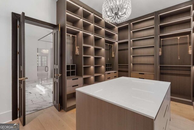 245 Traditions Dr, Alpharetta, GA 30004 - spacious closet featuring light wood-type flooring and a chandelier