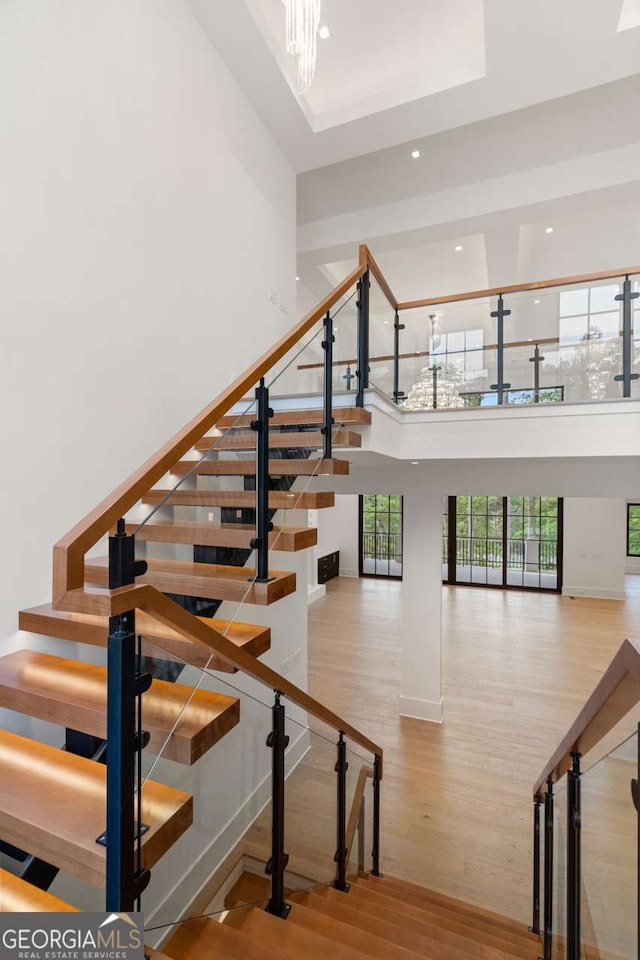 245 Traditions Dr, Alpharetta, GA 30004 - stairway with wood finished floors, a high ceiling, recessed lighting, and a chandelier