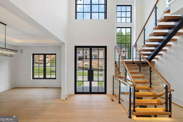 245 Traditions Dr, Alpharetta, GA 30004 - foyer with hardwood / wood-style floors, stairway, french doors, and a towering ceiling