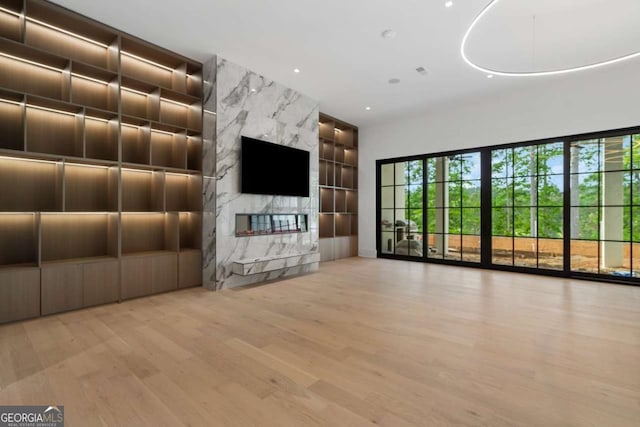 245 Traditions Dr, Alpharetta, GA 30004 - unfurnished living room with built in features, wood finished floors, a fireplace, and recessed lighting