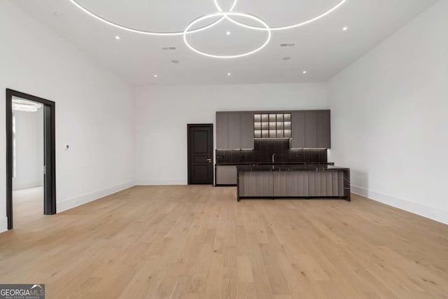 245 Traditions Dr, Alpharetta, GA 30004 - unfurnished living room with light wood-type flooring and recessed lighting