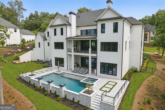 245 Traditions Dr, Alpharetta, GA 30004 - rear view of property featuring a chimney, a balcony, stucco siding, a fenced backyard, and a patio area