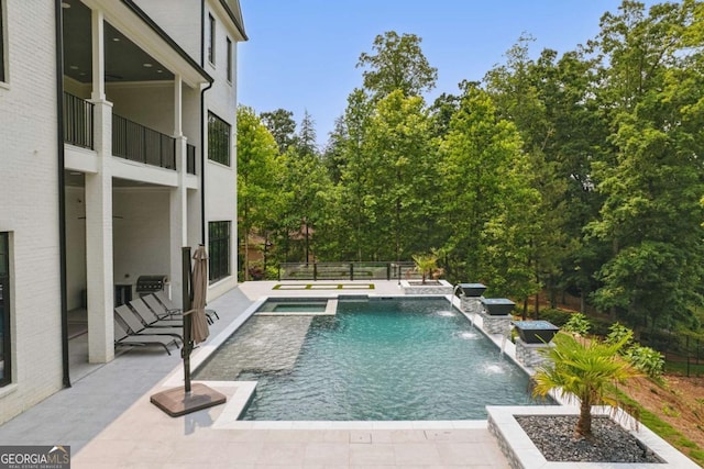 245 Traditions Dr, Alpharetta, GA 30004 - view of pool featuring a patio, a pool with connected hot tub, and view of scattered trees
