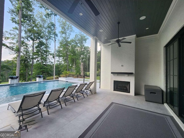 245 Traditions Dr, Alpharetta, GA 30004 - view of patio / terrace with a large fireplace, ceiling fan, an outdoor pool, and view of scattered trees