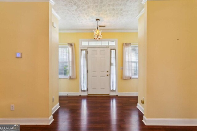 99 Rainwater Ln, Dallas, GA 30157 - foyer featuring ornamental molding, wood finished floors, a textured ceiling, and a chandelier