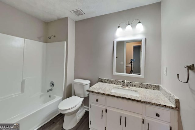 2478 Wood Meadows Dr SW, Marietta, GA 30064 - full bathroom featuring vanity, wood finished floors, shower / washtub combination, and a textured ceiling