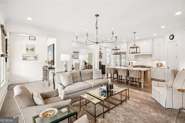 1057 Crossroads Trl, Milton, GA 30004 - living room featuring a chandelier, recessed lighting, light wood finished floors, and ornamental molding