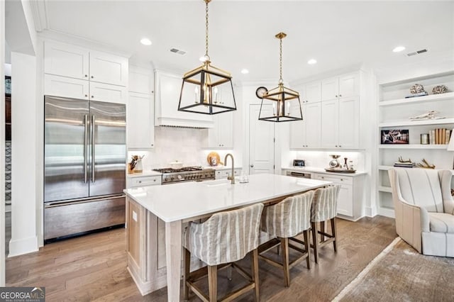 1057 Crossroads Trl, Milton, GA 30004 - kitchen with premium appliances, light countertops, white cabinets, and recessed lighting