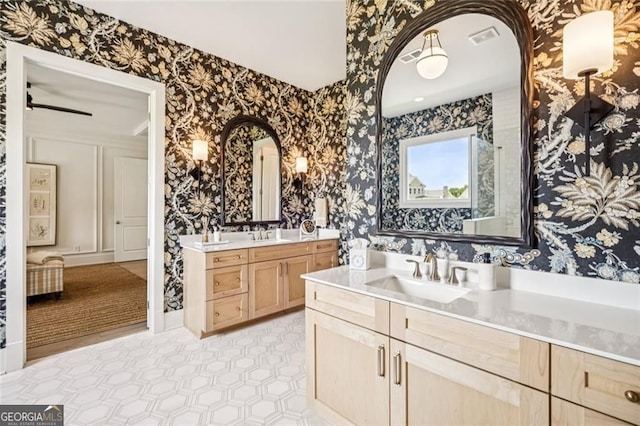 1057 Crossroads Trl, Milton, GA 30004 - bathroom with wallpapered walls, two vanities, and tile patterned floors