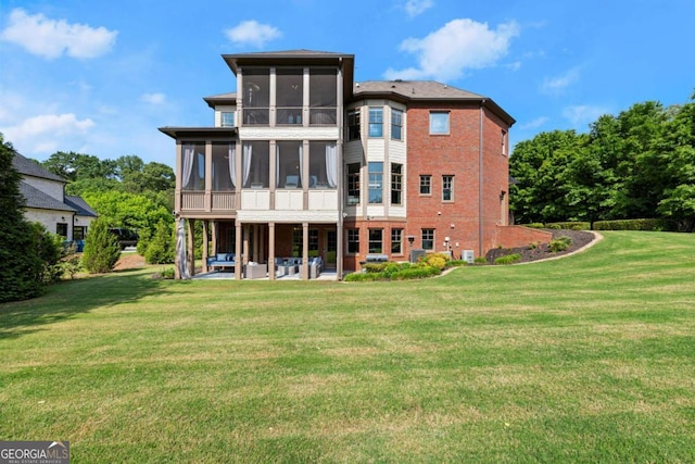 15815 Winterfield Way, Alpharetta, GA 30004 - back of property with a sunroom, an outdoor hangout area, a patio, and a yard