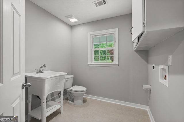 1000 Jones Rd, Cataula, GA 31804 - bathroom with toilet, baseboards, and tile patterned flooring
