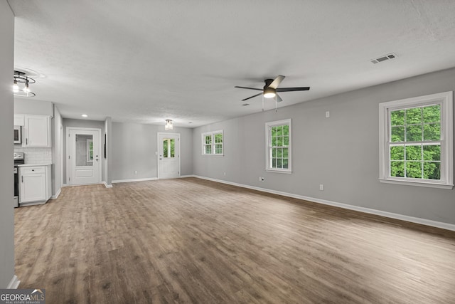 1000 Jones Rd, Cataula, GA 31804 - unfurnished living room featuring ceiling fan, wood finished floors, baseboards, and a textured ceiling