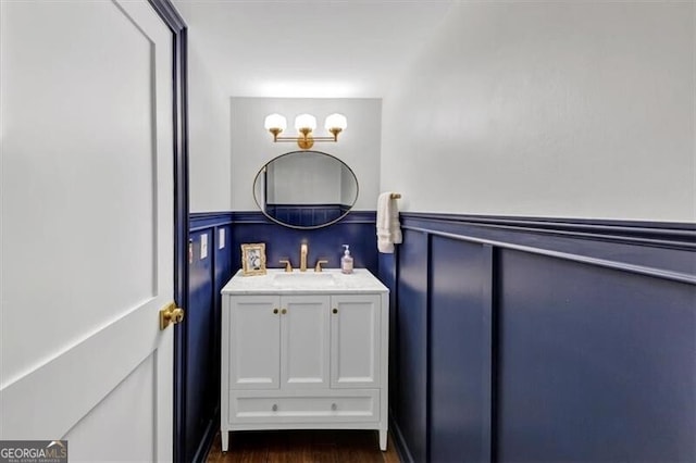 2 Arpege Way NW, Atlanta, GA 30327 - bathroom with vanity, a wainscoted wall, a decorative wall, and wood finished floors