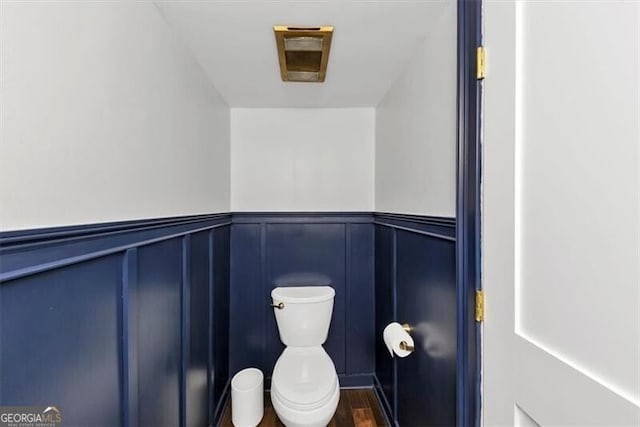 2 Arpege Way NW, Atlanta, GA 30327 - bathroom featuring toilet, a decorative wall, a wainscoted wall, and wood finished floors