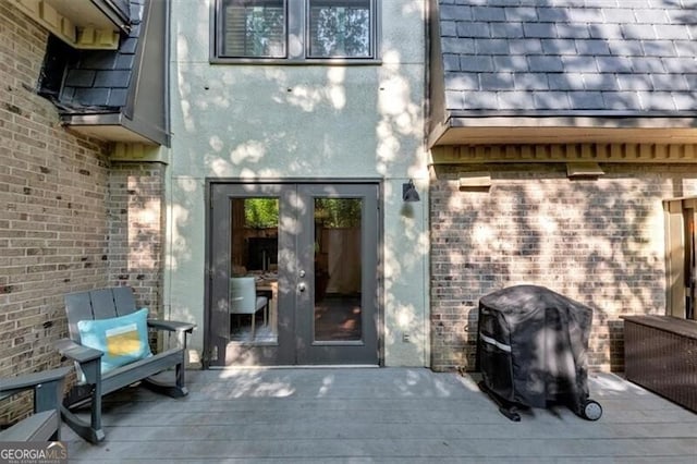 2 Arpege Way NW, Atlanta, GA 30327 - view of exterior entry featuring a deck, french doors, stucco siding, and brick siding
